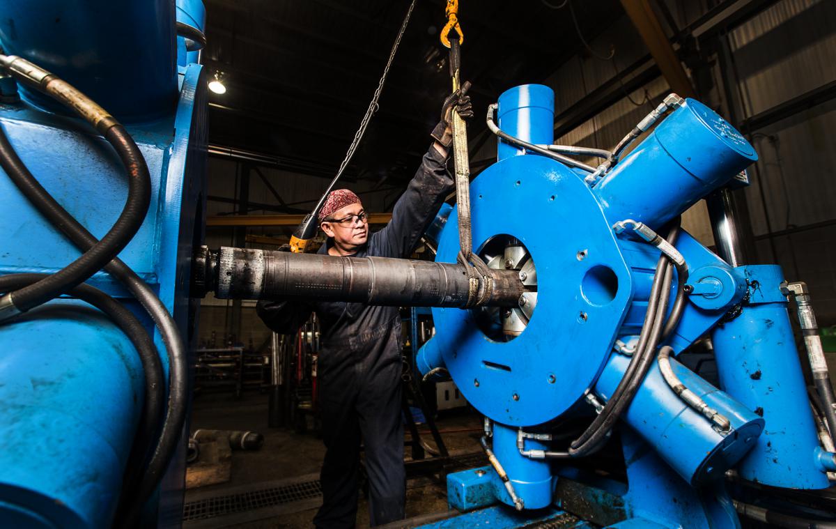 Technician working on a hydraulic test bench