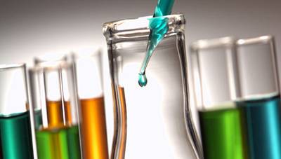 Test tubes of drilling fluid additives being decanted