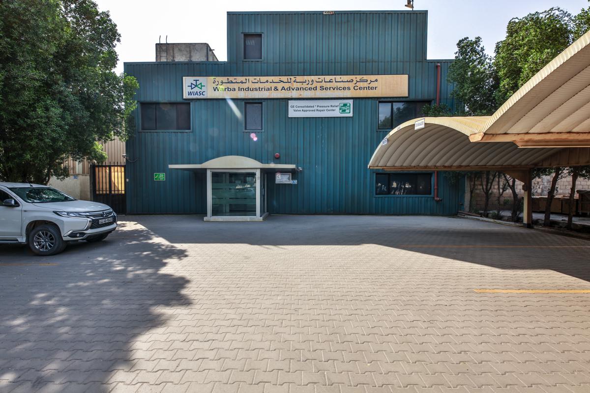 The WIASC building in the Shuaiba Industrial Area, its GE Consolidated approved repair centre plaque beside the entrance