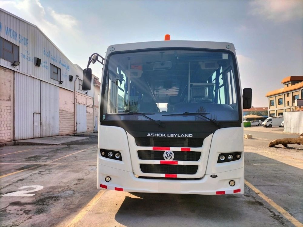 White Ashok Leyland passenger bus in the Warba yard